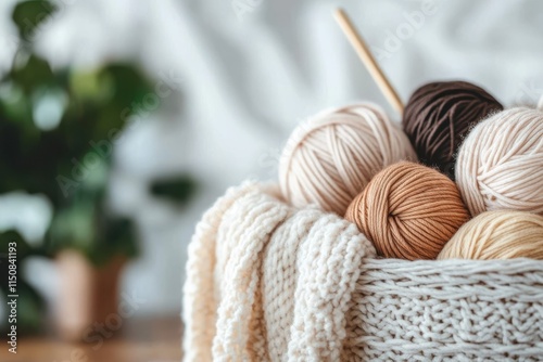 A snug basket containing yarn balls in warm earth tones sits prepared with knitting needles, capturing the essence of coziness and creativity in fiber artistry. photo