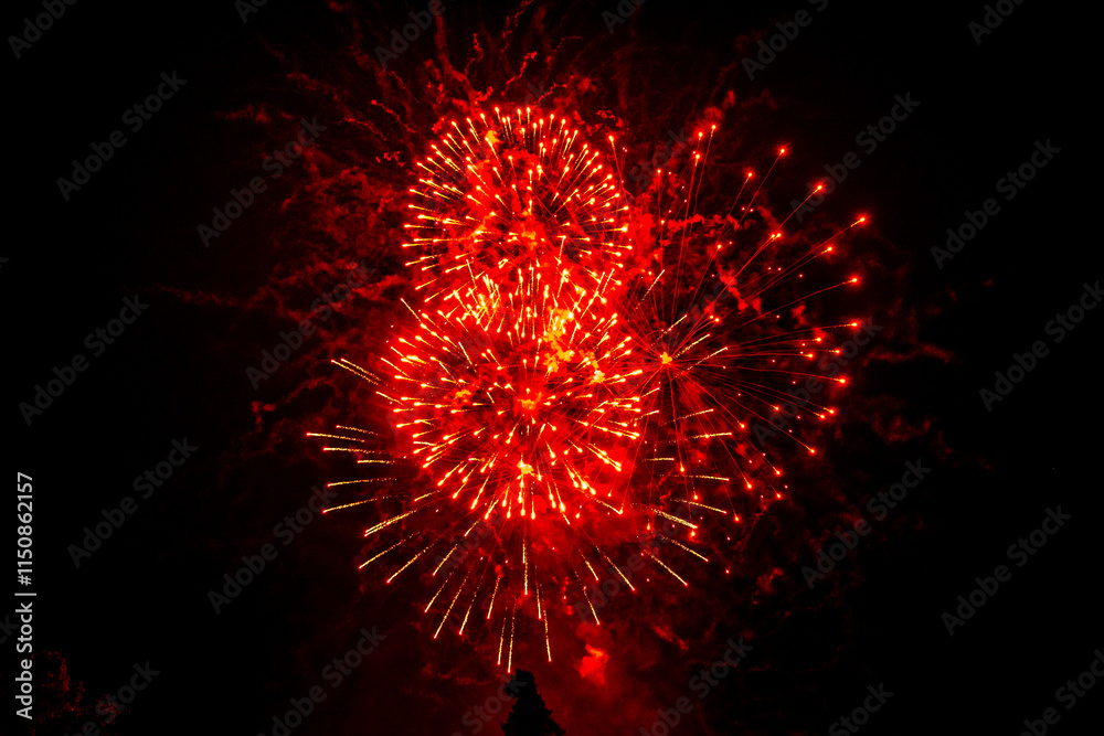 Beautiful red fireworks sparkle in the sky. Selective focus. Beautiful red fireworks sparkle in the sky. Selective focus.