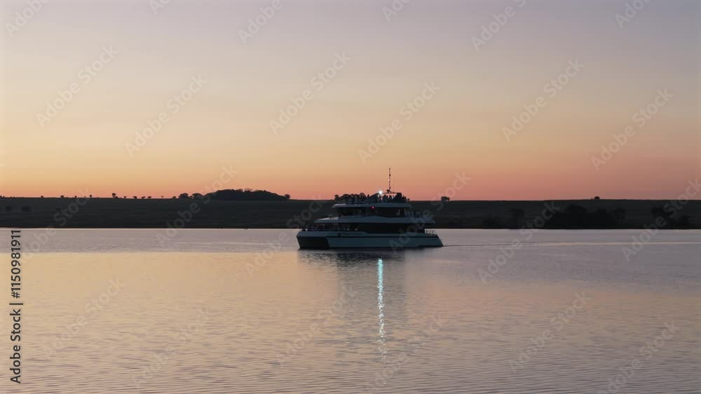 Aerial view of catamaran sailing on Paraná river at sunset. Misiones, Argentina. Aerial view of catamaran sailing on Paraná river at sunset. Misiones, Argentina.