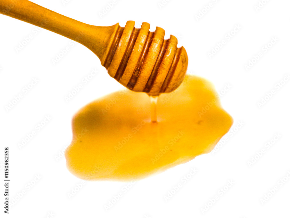 Natural honey dripping from dipper on white background Natural honey dripping from dipper on white background