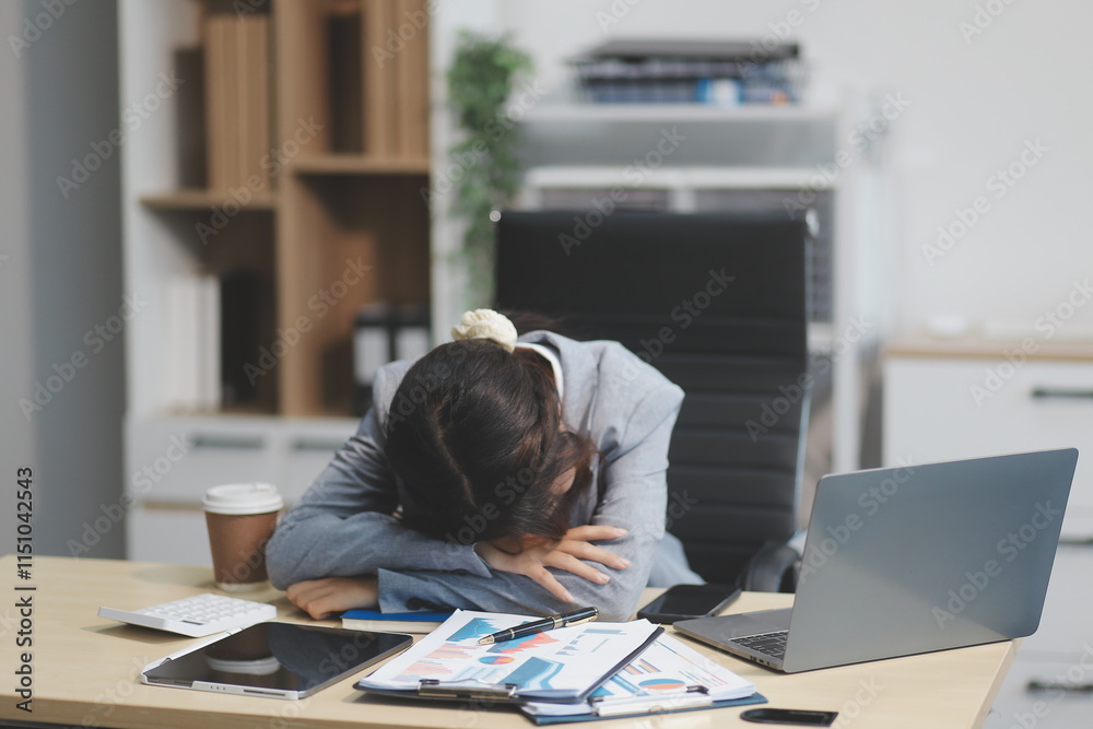 Asian women are stressed while working on laptop, Tired asian businesswoman with headache at office, feeling sick at work, copy space Asian women are stressed while working on laptop, Tired asian businesswoman with headache at office, feeling sick at work, copy space