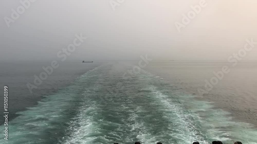 Experience the serene perspective from Shandong Yantai Bohai Ferry deck showcasing the tranquil waters and distant landscapes photo