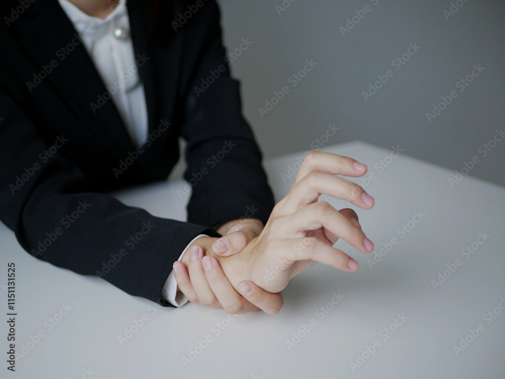 Fototapeta premium Young Asian woman feels numbness and severe pain in her wrist Caused by sitting and working for a long time Health care and office syndrome concept