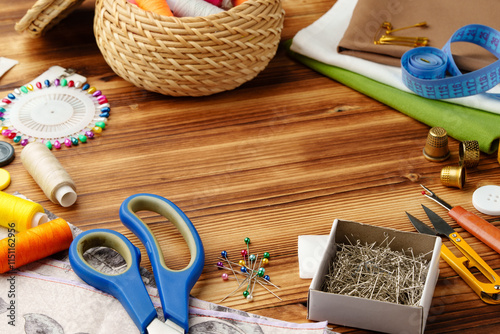 Crafting tools and materials arranged on a wooden table for sewing projects photo