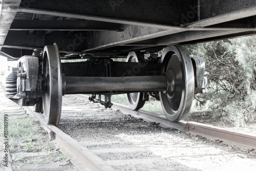 A train with its wheels on the tracks photo