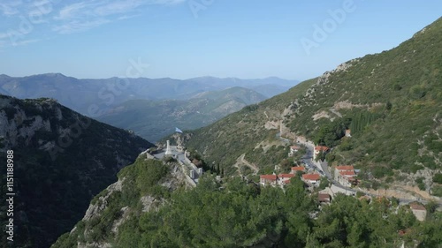 An aerial view of the World War II monument in Stemnitsa village, surrounded by a green background of trees photo