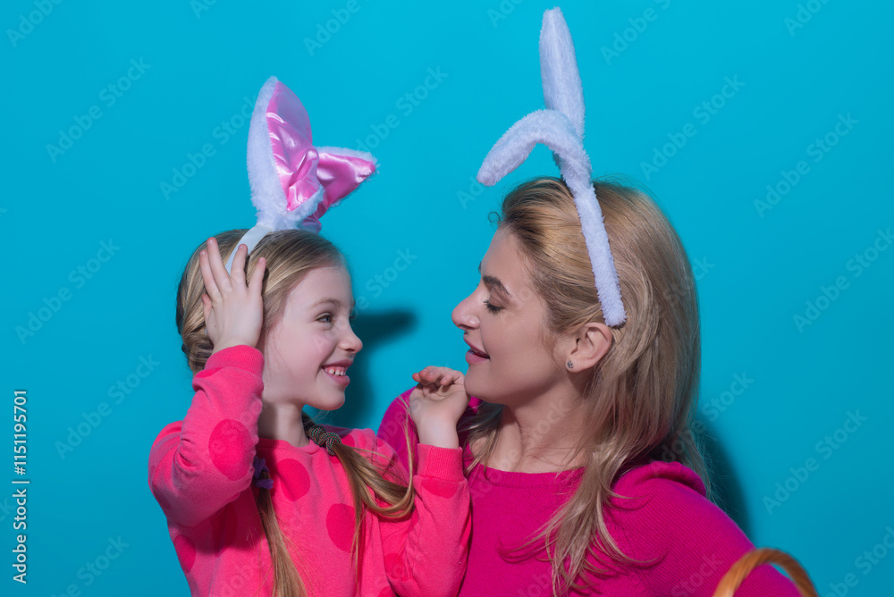 Easter holidays. A mother and her daughter painting Easter eggs. Happy family preparing for Easter, wearing easters bunny ears, studio portrait. Easter holidays. A mother and her daughter painting Easter eggs. Happy family preparing for Easter, wearing easters bunny ears, studio portrait.