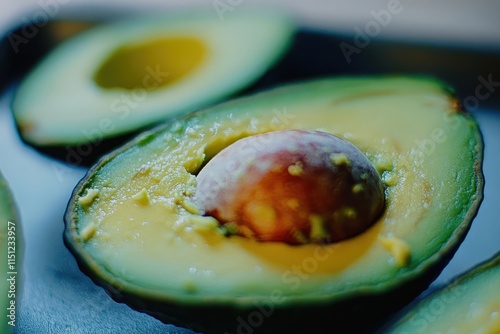 Close-up of halved avocados showing creamy flesh and pit. photo