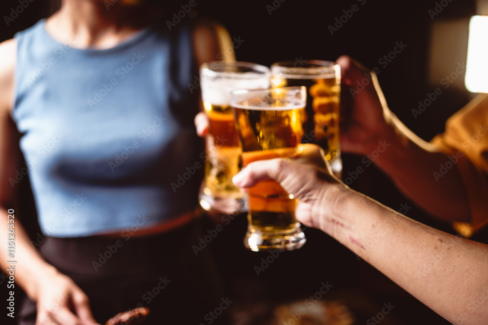 A man's and woman's hands raise beer glasses group in a lively night party, surrounded by family and friends. The evening is filled with warmth, laughter, and joyful celebration. A man's and woman's hands raise beer glasses group in a lively night party, surrounded by family and friends. The evening is filled with warmth, laughter, and joyful celebration.