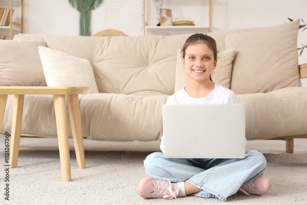 Teenage girl using laptop on floor at home Teenage girl using laptop on floor at home