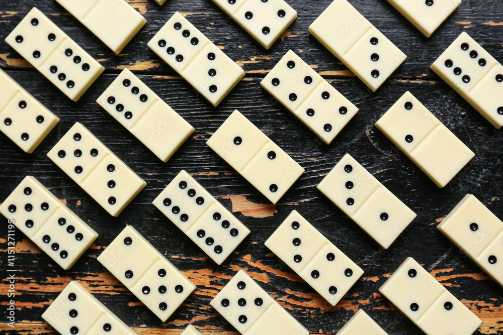 Texture of white dominos blocks on black wooden background Texture of white dominos blocks on black wooden background