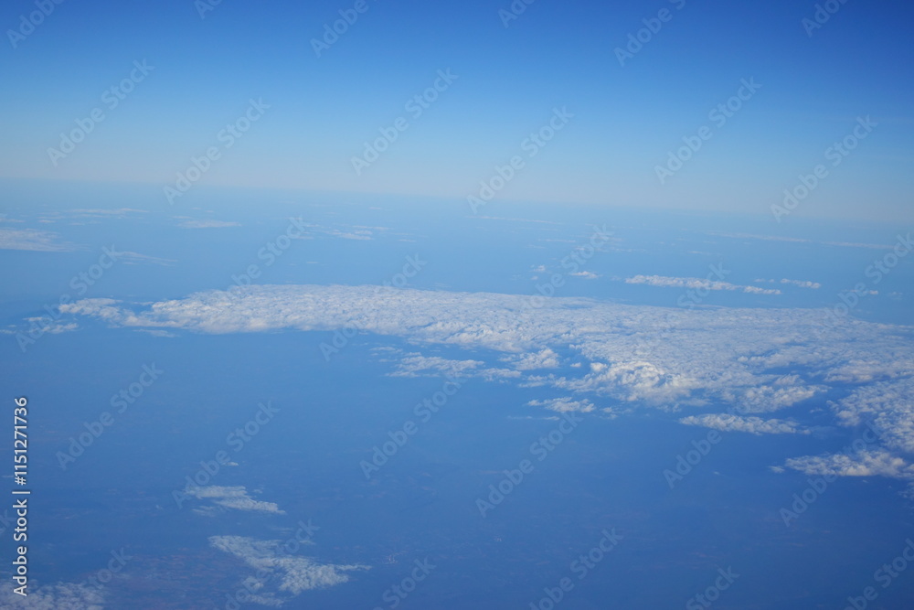 White clouds drift across the stratosphere against a blue sky. A few clouds dot the otherwise brilliant and pure sky. As if gazing up at a picturesque day, the scene is calm and tranquil. White clouds drift across the stratosphere against a blue sky. A few clouds dot the otherwise brilliant and pure sky. As if gazing up at a picturesque day, the scene is calm and tranquil.