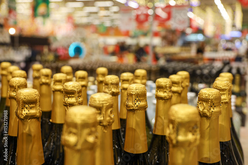 Champagne bottles in a row, selective focus. Liquor store, sparkling wine production concept