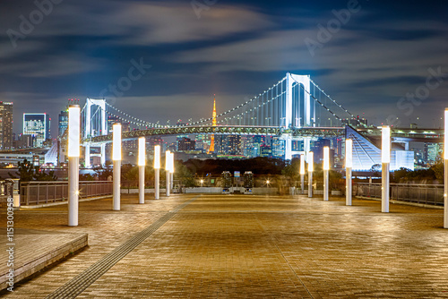 Japan Travel Concepts. Colorful and Illuminated Rainbow Bridge with Tokyo Tower in Background At Dusk.