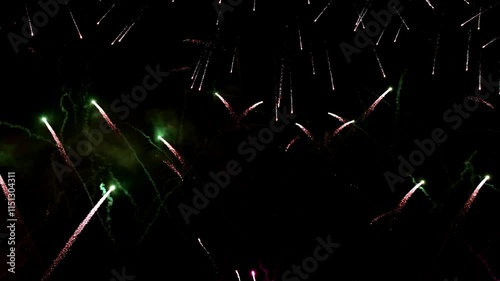 Bright colorful festive glowing fireworks on night sky.  New Year, Christmas, festival, party and holiday celebration concept