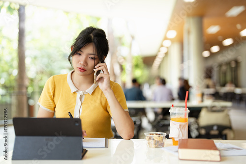 Informal Call. young asian woman calling her friend, talking about homework, using laptop photo