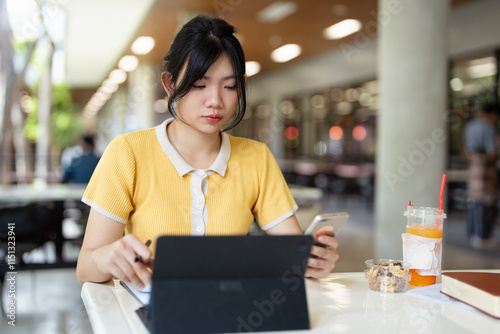 Young teen girl college student holding smartphone studying on cell, distance learning using apps for education, elearning on mobile phone in university campus or creative office. photo