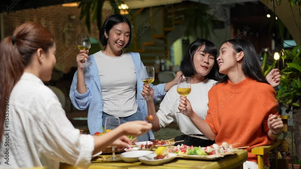 Group of young Asian friends enjoying dinner party together Barbecue grilling, drinking beer, people, food, healthy fruits and vegetables, celebrating, lifestyle drinks. New Year celebration concept. Group of young Asian friends enjoying dinner party together Barbecue grilling, drinking beer, people, food, healthy fruits and vegetables, celebrating, lifestyle drinks. New Year celebration concept.