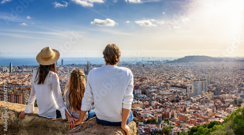 Obraz na płótnie A tourist family enjoys the panoramic view of the skyline of Barcelona, Spain, during their city trip vacation w salonie