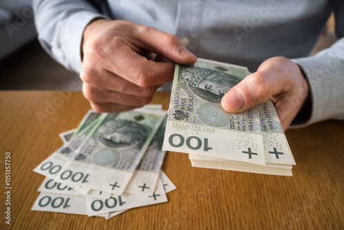 Obraz na płótnie A person counting Polish money. Business and savings.
w salonie