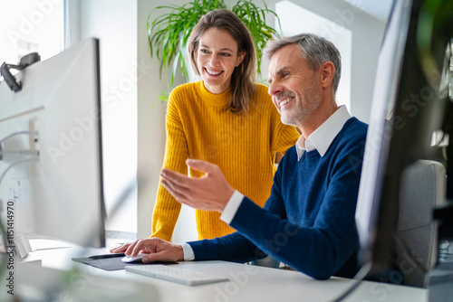 Businesswoman advising colleague at office photo