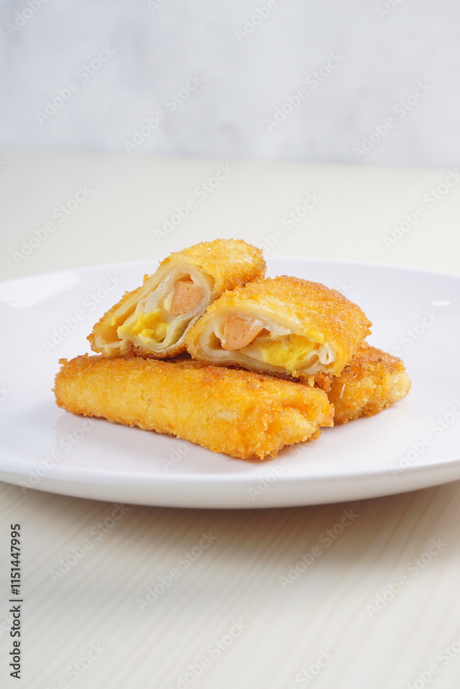 mayonnaise rissoles enclosed in crepe-like wrappers and rolled into bread crumbs and fried. served on wood plate. perfect for recipe, article, catalogue, promotion, or any cooking contents. mayonnaise rissoles enclosed in crepe-like wrappers and rolled into bread crumbs and fried. served on wood plate. perfect for recipe, article, catalogue, promotion, or any cooking contents.