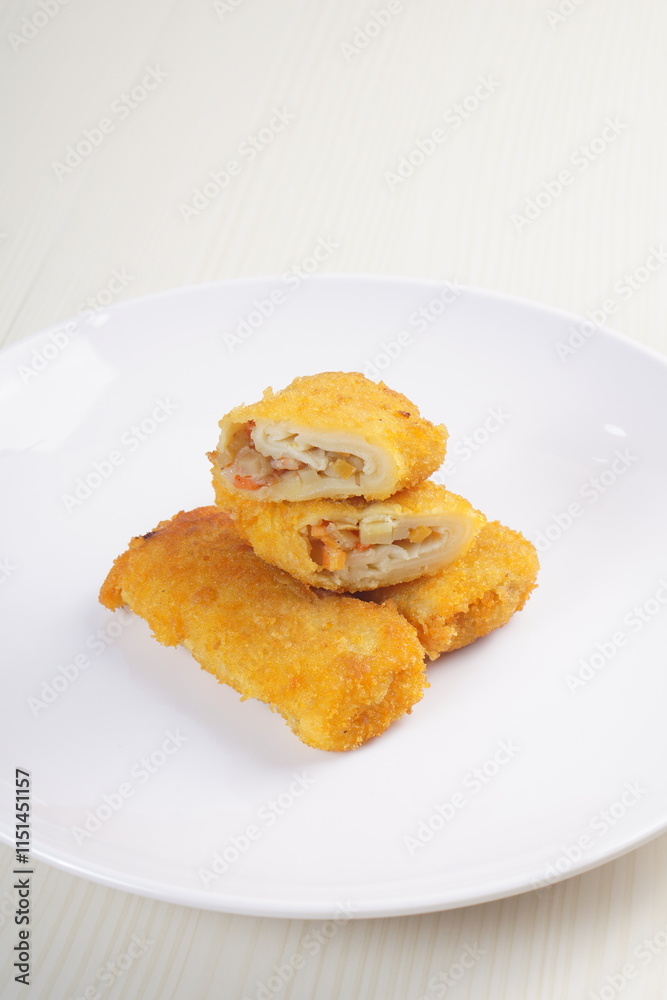vegetables risoles enclosed in crepe-like wrappers and rolled into bread crumbs and fried. served on wood plate. perfect for recipe, article, catalogue, promotion, or any cooking contents. vegetables risoles enclosed in crepe-like wrappers and rolled into bread crumbs and fried. served on wood plate. perfect for recipe, article, catalogue, promotion, or any cooking contents.
