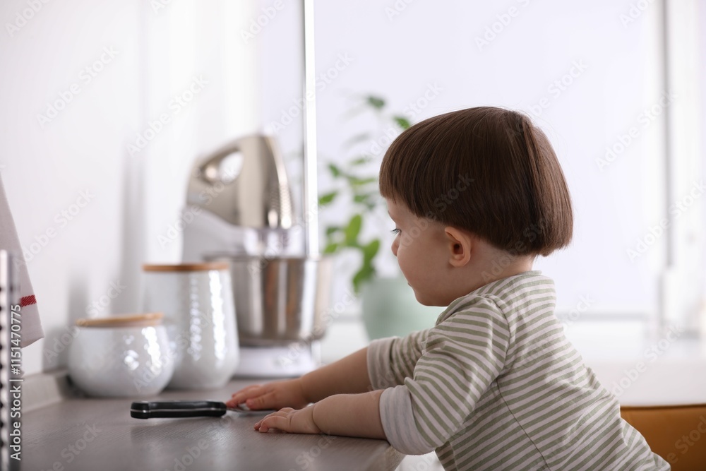 Little boy reaching towards knife on kitchen counter. Dangerous situation Little boy reaching towards knife on kitchen counter. Dangerous situation