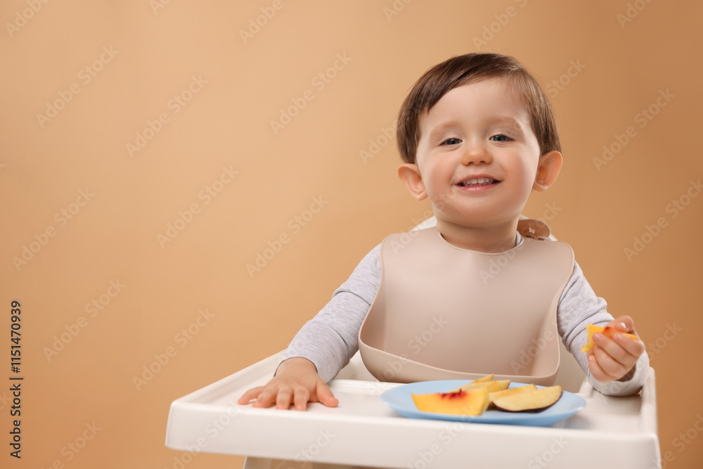 Healthy baby food. Cute little kid eating fruits in high chair on beige background, space for text Healthy baby food. Cute little kid eating fruits in high chair on beige background, space for text