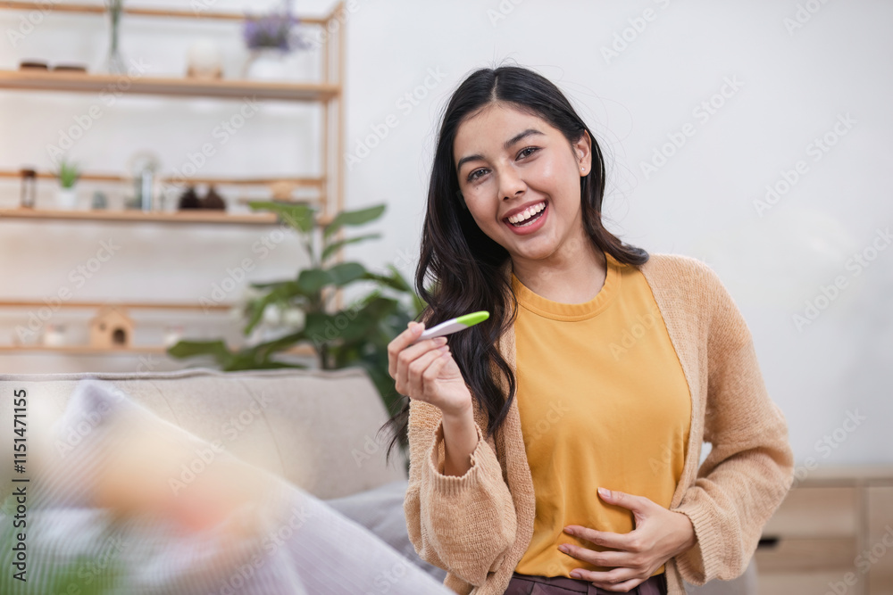 Exciting pregnancy test result celebrated by woman in cozy living room embracing new womb journey Exciting pregnancy test result celebrated by woman in cozy living room embracing new womb journey
