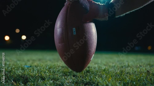 Cinematic shot of American Football player Kickoff Game Start. Static Close-up of Ball Being Kicked by the Professional Player. Gates Goal Kick. Successful Team Scores and Wins Championship. photo