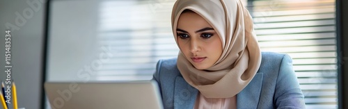 Focused Professional Woman in Hijab Working photo