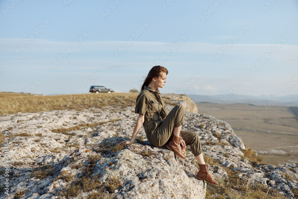 Woman sitting on cliff edge with car in background, enjoying scenic travel adventure and serene beauty of nature Woman sitting on cliff edge with car in background, enjoying scenic travel adventure and serene beauty of nature