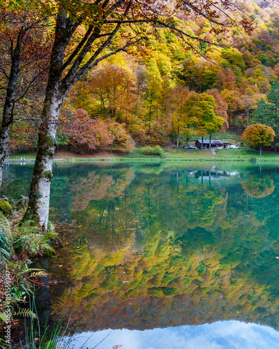 Bethmale lake in Ariège in autumn with colorful foliage.