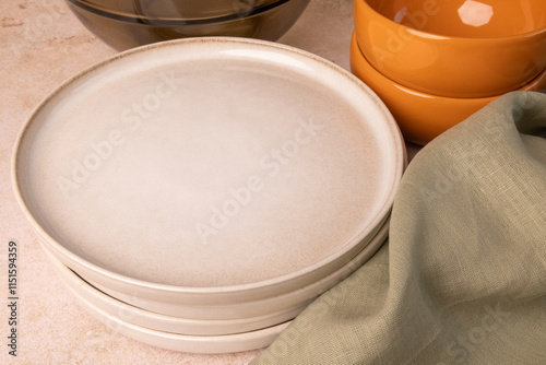 A selection of tableware on a brown stone tabletop.