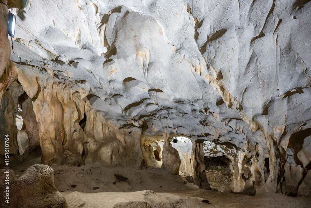 Naklejka premium Interior of the large hall of old Karain cave, hidden in Mediterranean region. Confirms human habitation since the early Paleolithic age between 150,000 and 200,000 years ago.Yagca, Antalya, Turkey.