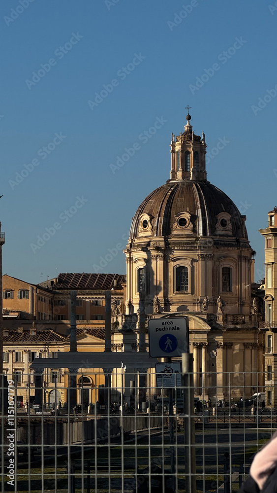 Fototapeta premium The stunning historical architecture of Rome features an intricately designed dome that beautifully contrasts with the clear blue sky, especially during the enchanting golden hour