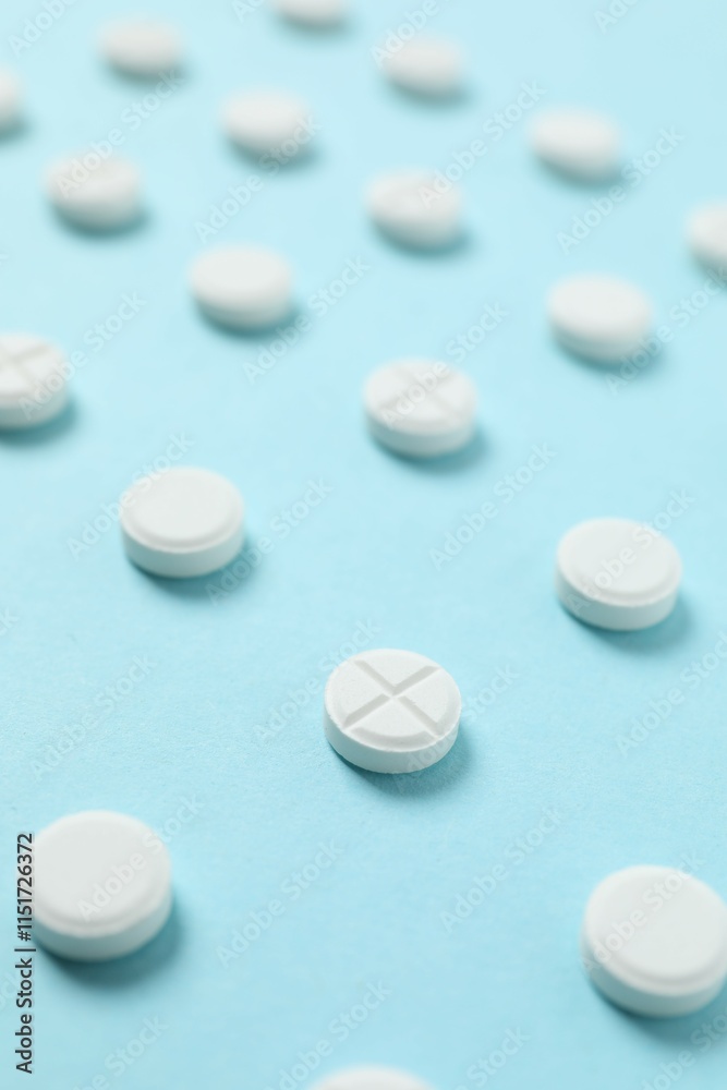 White pills on a colored background White pills on a colored background