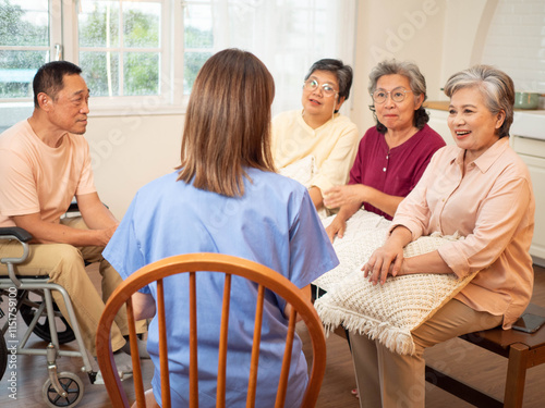 backside woman female nurse blue uniform clinic hospital consulting patient senior elderly help hope listening conversation retirement dvice doctor talking group support visit physician healthcare 