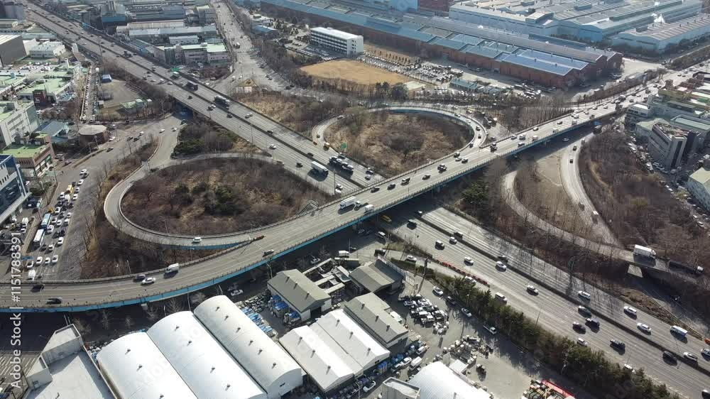 Aerial view of a complex highway cloverleaf interchange showcasing intricate traffic patterns and road network design.