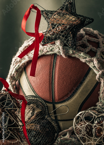 Obraz na płótnie Basketball ball inside of mesh net string decoration with Christmas tree mesh case, Star mesh case and Heart mesh case on black background. sports play on christmas, Christmas-themed event basketball w salonie