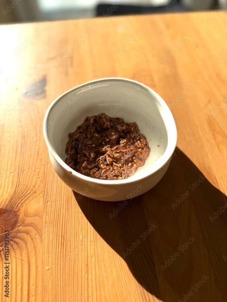 Chocolate oatmeal porridge on wooden table Chocolate oatmeal porridge on wooden table