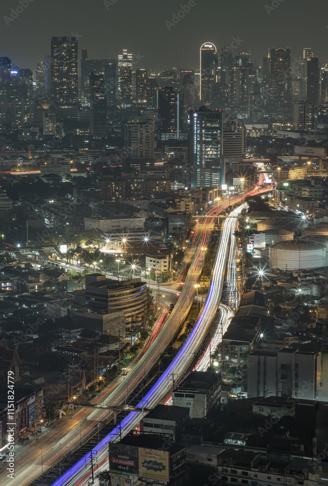 Night view of light trails of cars on the road of Bangkok city. Nightscape view of with bright glowing lights after sunset, Long exposure for Light curve lines, use it as your Wallpaper, Poster.