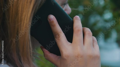 Unrecognizable woman head talking mobile phone calling on smartphone. Close up.