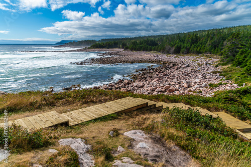 Canvas Print A view down wooden steps along the rocky shore at Green cove, Ingonish on the Ca