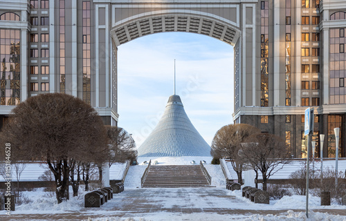 View of Khan Shatyr center framed by a grand arch in snowy Astana, Kazakhstan architecture