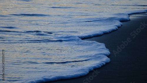 Photos The soft hues of the setting sun reflect off the gentle, quiet waves, creating an atmosphere of peace and intimacy