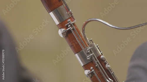 A bassoon player playing their instrument during a live performance of a wind band