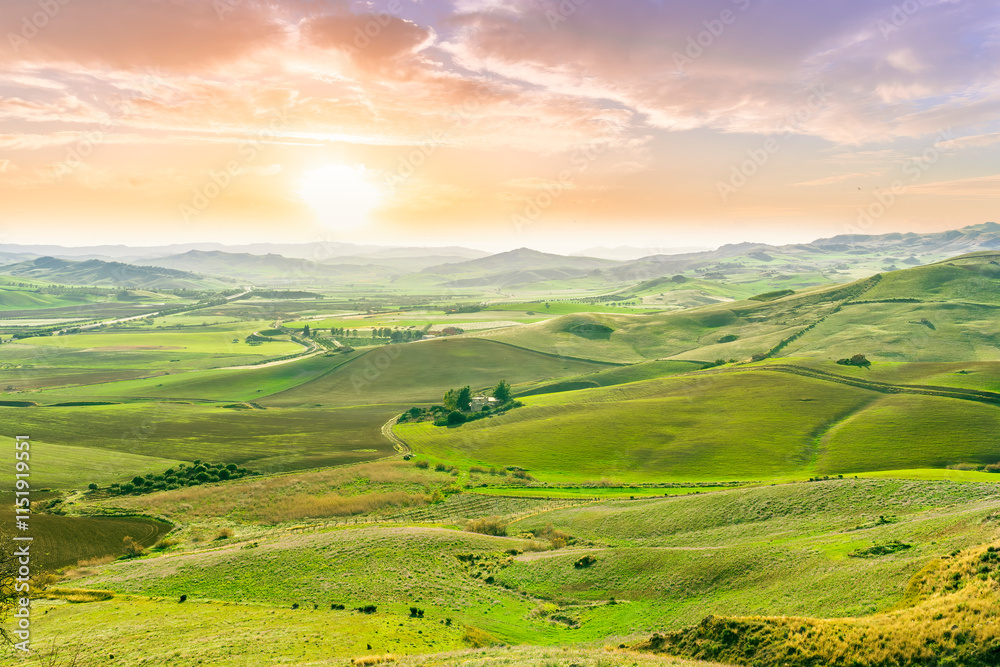 Fototapeta premium green spring season landscape of beautiful grassland hills in countryside with villages and mountains under scenic cloudy sky