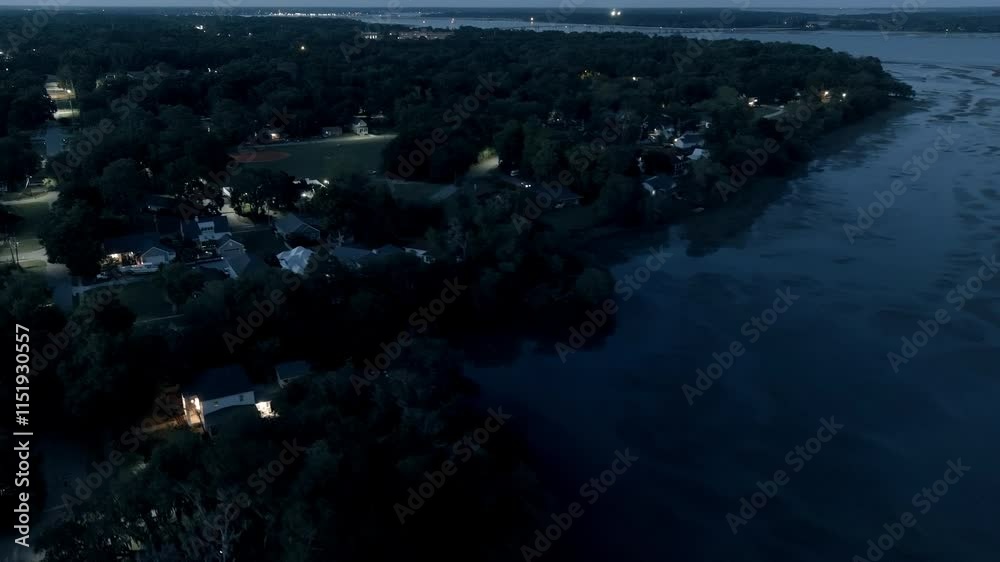 Aerial night time view flying over the small town of Port Royal, South Carolina with the river in the background.